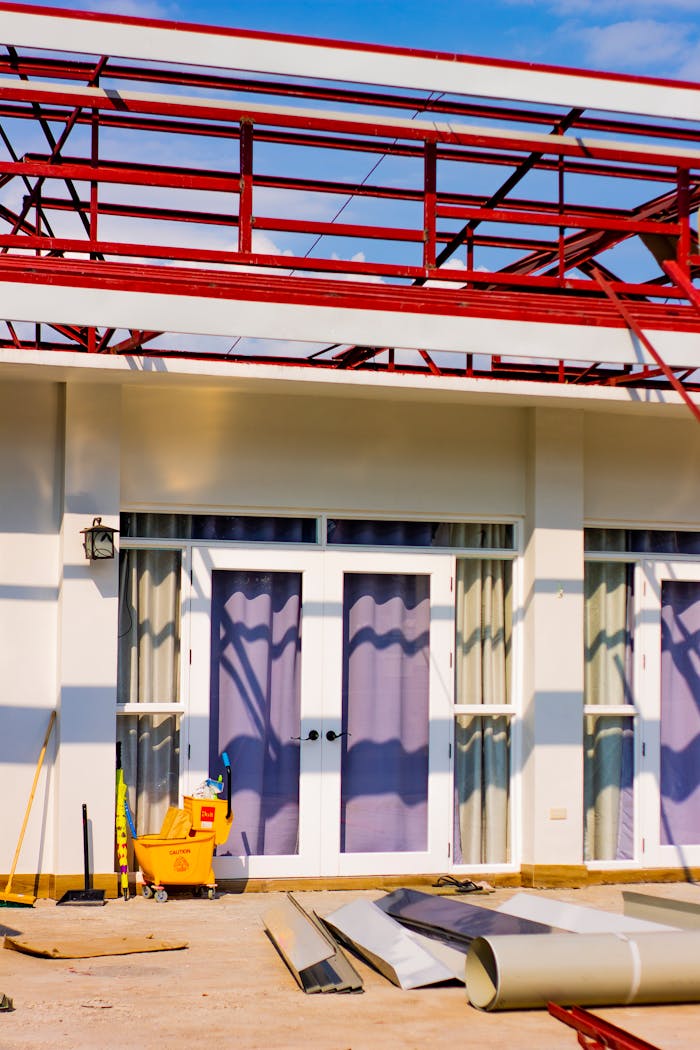 Construction materials and scaffolding seen during a house renovation project.